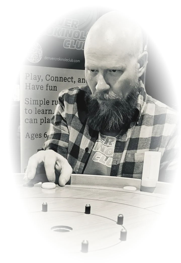 Club founder Justin Morgan lining up a shot at a crokinole board